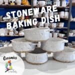 Handmade stoneware baking dishes with textured designs stacked in a pottery studio